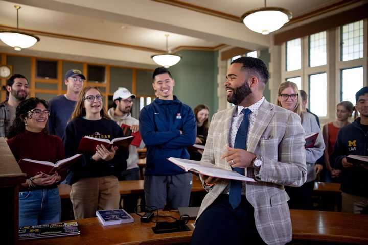 Professor lecturing at the front of a classroom