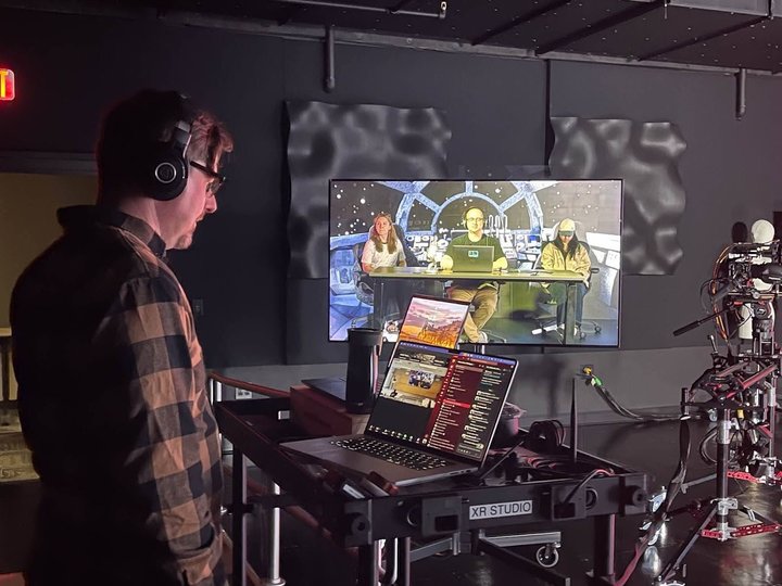Media designer watching a recording monitor in a studio